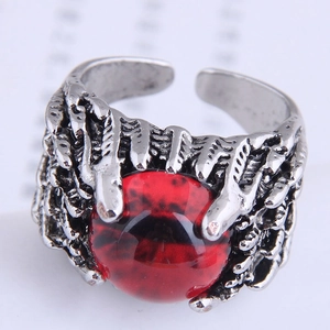 Macro detail of gothic claw ring in antique silver with a striking red eye centerpiece