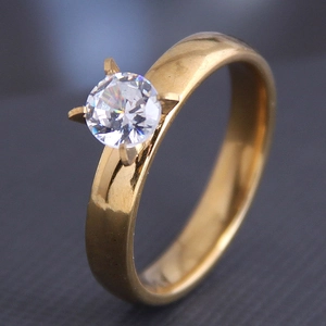 Macro view of gold stainless steel ring with a four-prong set round cubic zirconia stone