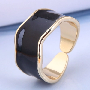 Detailed shot of a gold-plated irregular wavy ring with black enamel and adjustable opening