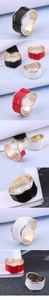 Detail showing wave-shaped gold rings with colorful drip oil finish in black and red
