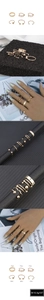 Detail view of 6-piece gold bead ring set featuring textured bands and layered stacking rings
