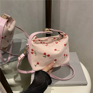 Pink corduroy handbag with cherry embroidery and adjustable strap for casual wear