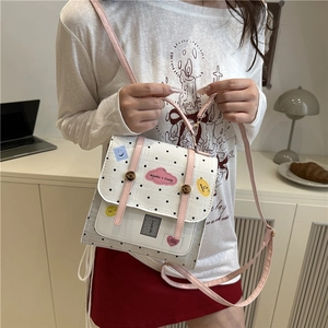 Polka dot white backpack with pink straps and cute patches for casual daily wear