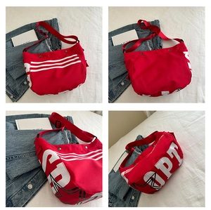 Détails du grand sac bandoulière en toile rouge avec rayures blanches et lettrage OPT