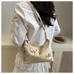 Detail of off-white silk crossbody bag with floral embroidery and pearl drawstring detail