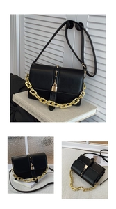 Detail of black leather crossbody bag featuring gold chunky chain and metallic lock