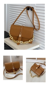 Detail of brown shoulder bag with chunky gold chain and metallic lock on faux leather
