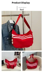 Détail du sac en toile rouge avec motifs ondulés blancs et bandoulière ajustable