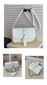 Detail of white vintage crossbody bag with gold padlock hardware and chunky metal chain