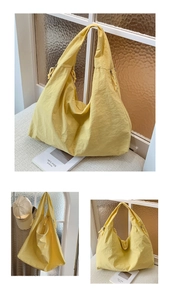 Detail of yellow nylon tote bag featuring natural pleated texture and side drawstring