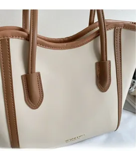 Detail of minimalist tote bag showing stitching and FASHION & BAGS lettering at bottom
