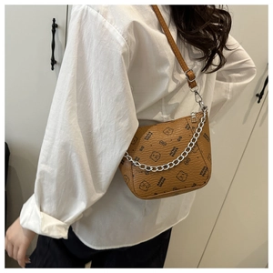 Close-up of brown bucket bag with lychee texture and silver chain strap for women