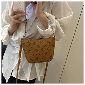 Detail of brown leather crossbody bag with cartoon bear prints and silver chain handle