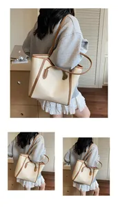 Detail of cream tote bag with brown trim and dual handles shown from multiple angles