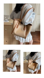 Detailed views of a large beige tote bag with brown leather handles and brand lettering