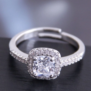 Macro shot of cushion-cut cubic zirconia ring with halo setting and adjustable silver band