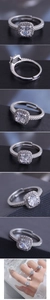 Close-up of adjustable silver ring with cushion-cut zircon and halo setting on finger