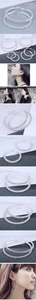 Detail of silver hoop earrings with white crystals showing multiple sizes and model wear