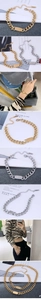 Detailed view of stainless steel curb chain bracelet with polished metal plate in gold and silver
