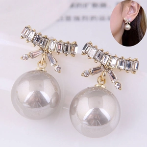 Bowknot earrings with rectangular cubic zirconia and a grey metallic pearl drop