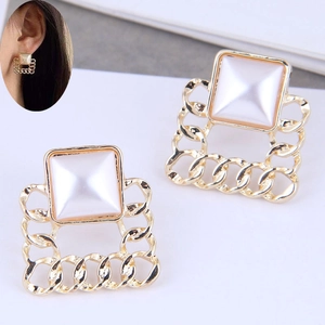 Close-up of square champagne gold earrings with pearlescent center and chain texture
