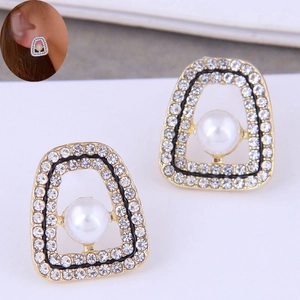 Detail of vintage trapezoid earrings with sparkling rhinestones and center pearl