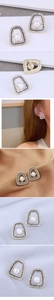 Detail of geometric trapezoid earrings with crystals, black enamel, and white pearls