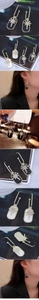 Detail of long rectangular drop earrings with starburst pattern and micro-zirconia inlays