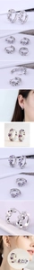 Macro detail of S925 sterling silver flower hoop earrings with cubic zirconia stones