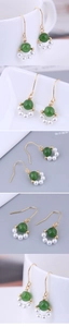 Detailed close-up of handmade gold wire-wrapped earrings with green stones and pearls