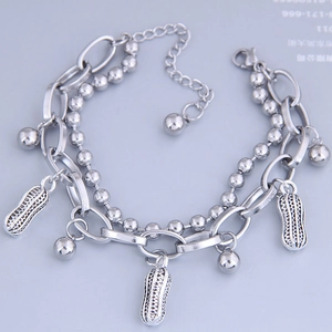 Detail of silver double-layered bracelet with peanut pendants and ball chain accents