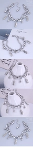 Detailed view of layered stainless steel bracelet with peanut pendants and bead chains