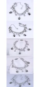 Detail of silver double-layer bracelet with crown charms and bead chain texture