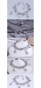 Detail of layered stainless steel bracelet with bead chains and vintage rabbit pendants