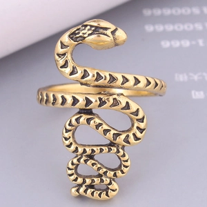 Macro shot of vintage gold snake ring featuring intricate scale textures and coiled design