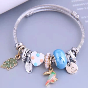 Handmade stainless steel twisted open bangle with colorful bird and leaf pendants