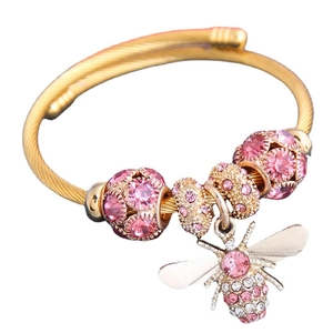Gold wire twist bracelet with pink crystal beads and a sparkling bee charm accessory