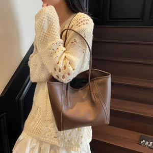 Brown leather tote bag for women, minimalist shoulder bag styled with an elegant outfit