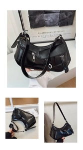 Close-up of black crescent underarm bag showing shiny pleated texture and silver zippers