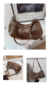 Detail of vintage brown leather shoulder bag with glossy finish and silver metal hardware