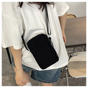 Vertical black crossbody phone bag with adjustable strap and front pocket detail