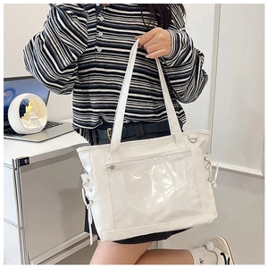 Detail view of large white ita bag with clear window and side drawstring ties