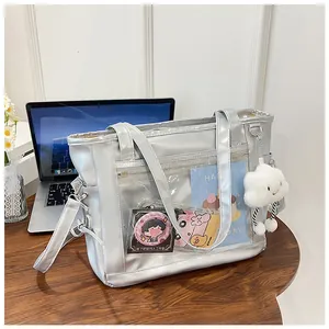 Detail of silver metallic tote bag featuring a clear window and plush white cloud charm