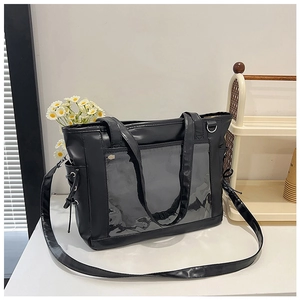 Close-up of black Itabag showing the transparent PVC window and durable PU leather handles
