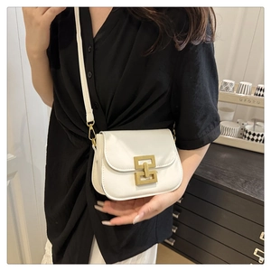 Close-up of minimalist white leather square crossbody bag with gold geometric buckle