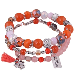 Three-layer bohemian beaded bracelet set with orange beads, tassel and silver clover charm