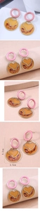 Detailed view of pink and amber resin earrings with heart metal frame and 4.2cm dimensions