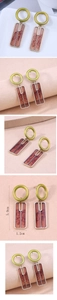 Detail view of geometric drop earrings with green circles and marble resin inserts