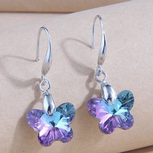 Macro detail of butterfly crystal drop earrings with purple-blue gradient and silver hooks