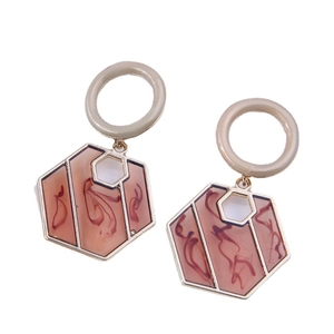 Minimalist geometric hexagon earrings with cream resin circles and marble texture